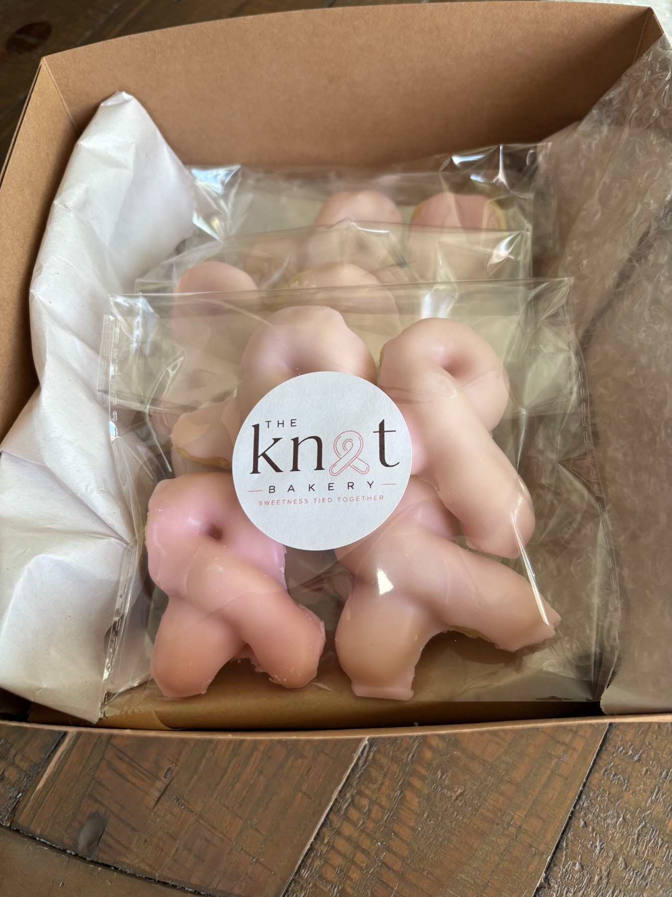 Pink Knot cookies packaged in a gift box with The Knot Bakery label