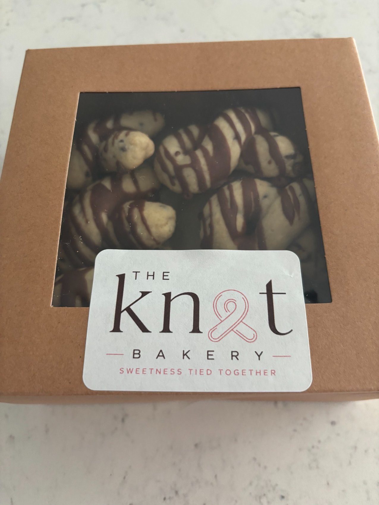 A window box of chocolate drizzled cookies