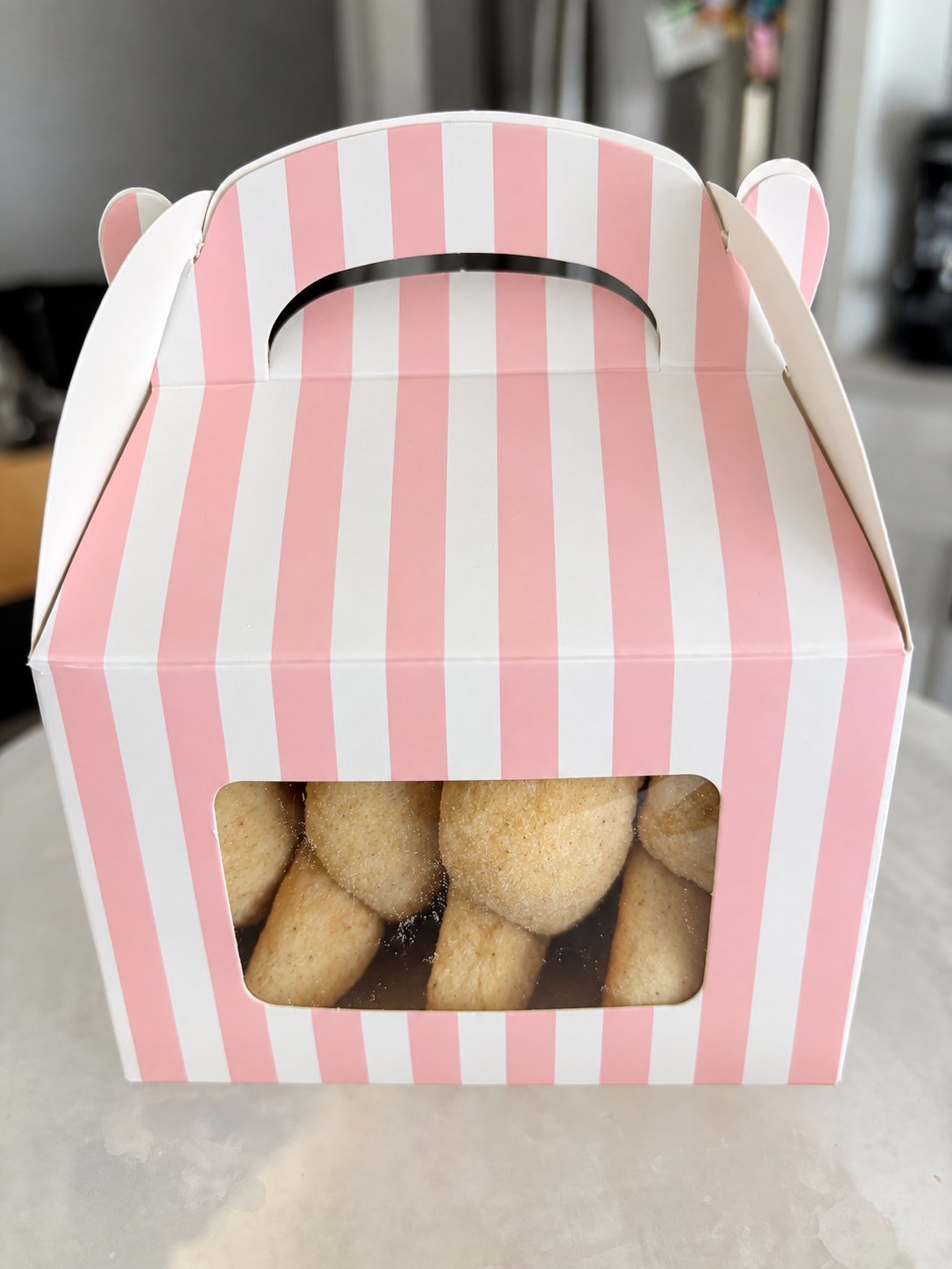 A pink striped box filled with Knots