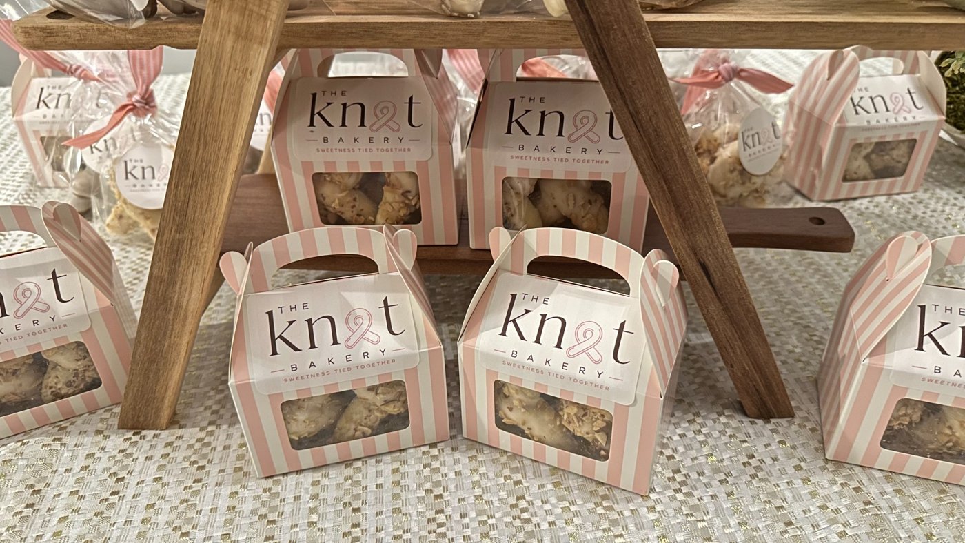 Pink striped cookie boxes at the bakery display