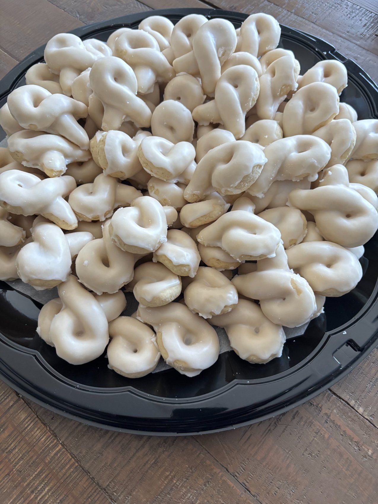 A serving platter piled with glazed Lemon Knots